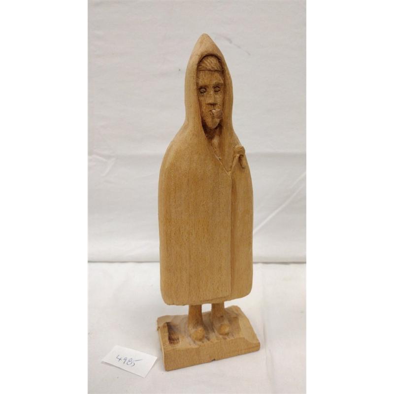 WOOD CARVING OF A FIGURE WEARING A PONCHO