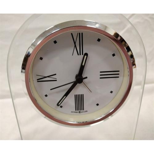 HOWARD MILLER QUARTZ CLOCK IN PLEXIGLAS STAND