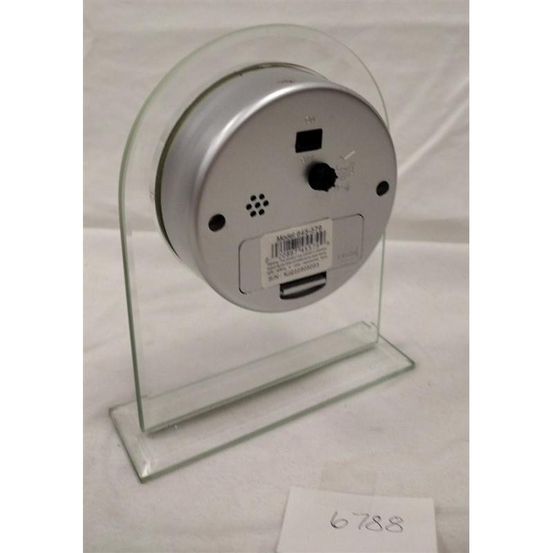 HOWARD MILLER QUARTZ CLOCK IN PLEXIGLAS STAND