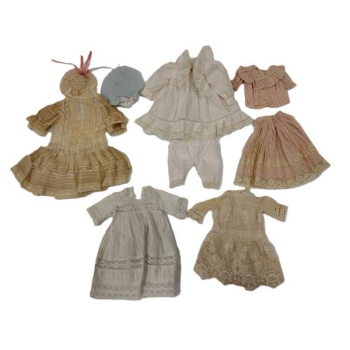 FIVE HAND AND MACHINED MADE DOLL DRESSES AND ACCESORIES
