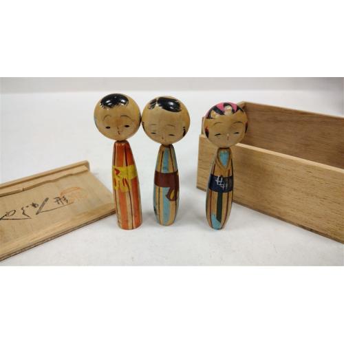 THREE VINTAGE JAPANESE KOKESHI DOLLS STORED IN WOODEN TEA BOX