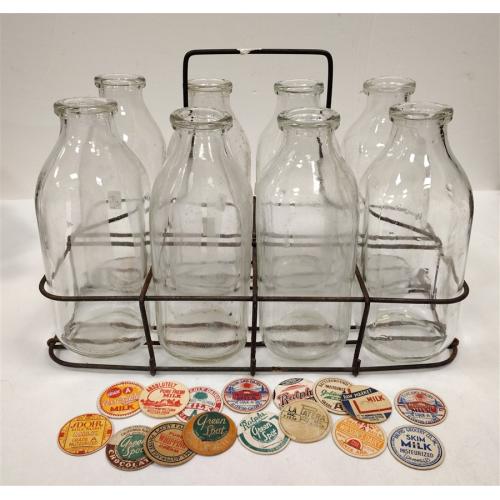 VINTAGE WIRE RACK OF EIGHT 1QT GLASS MILK BOTTLES WITH CARDBOARD CAP TOPS