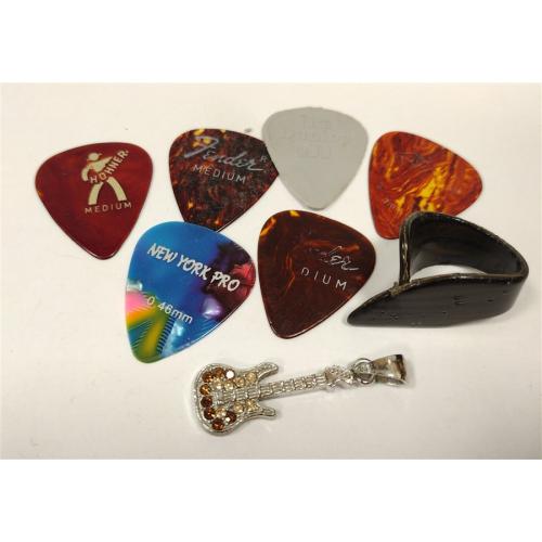 SEVEN VINTAGE GUITAR PICKS AND RHINESTONE GUITAR PENDANT