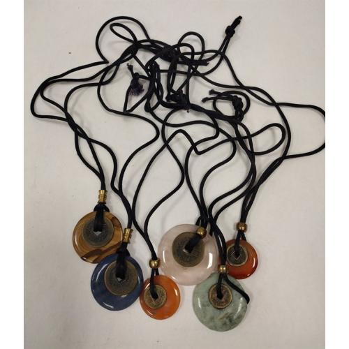 SIX CHINESE STONE CIRCLE PENDANTS ON SILK CHAINS